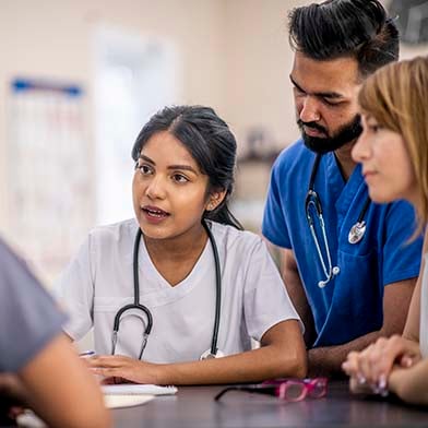A%20medical%20professional%20explaining%20something%20to%20her%20team