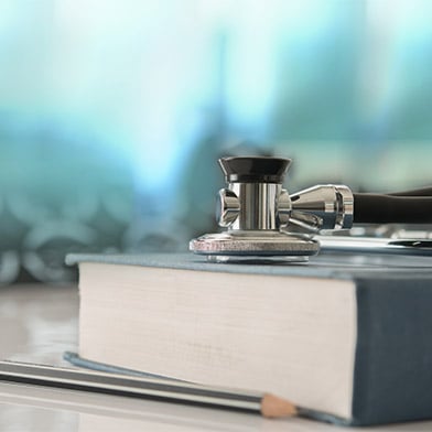 Stethoscope%20with%20medical%20text%20book%20on%20doctor%20student%20desk%20at%20classroom%20in%20the%20hospital.