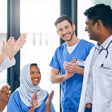 A group of doctors and nurses clapping