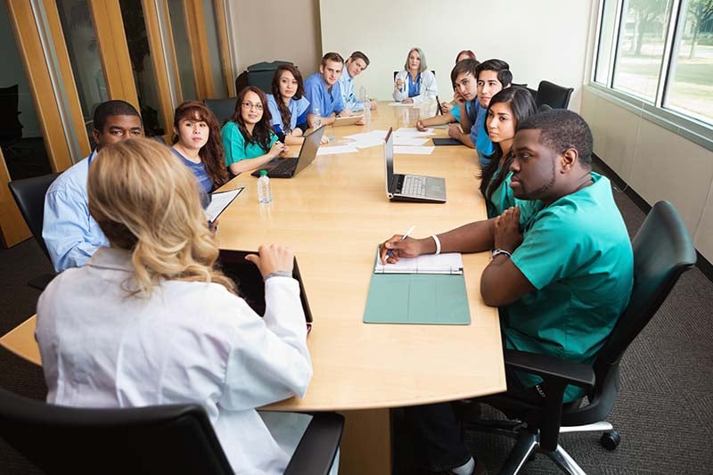 A group of medical professionals sitting around a table