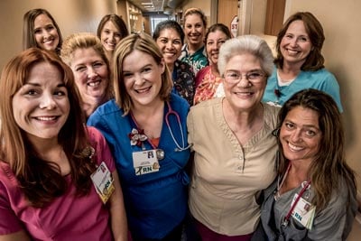 Happy group of smiling real nurses in Anne Arundel Medical Center hospital hallway