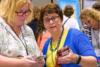 two nurses exchanging phone numbers at ANA Quality and Innovation Conference