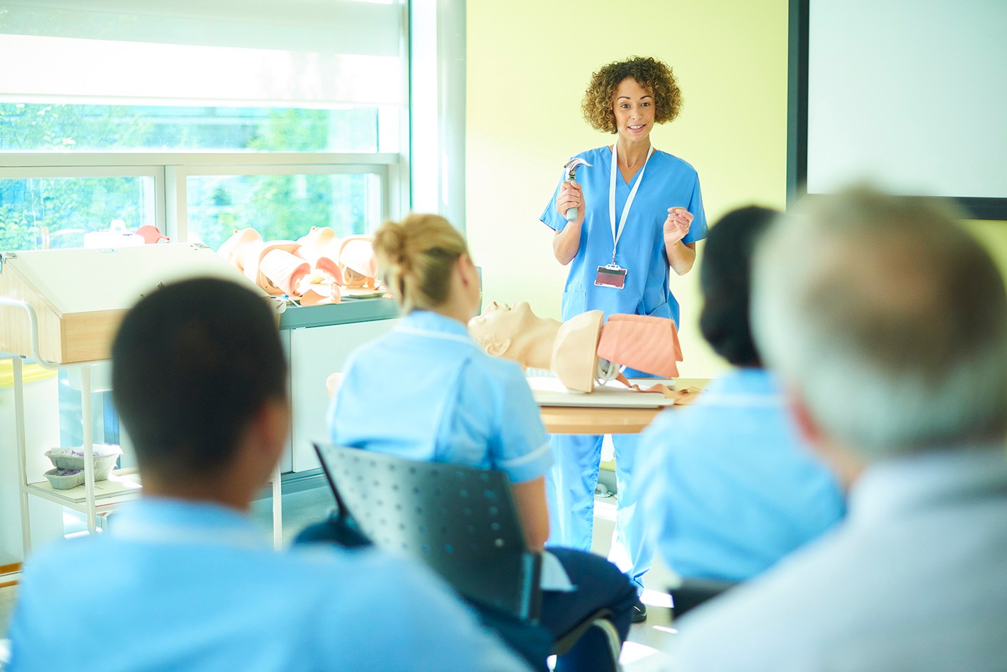 nurse educator in front of classroom
