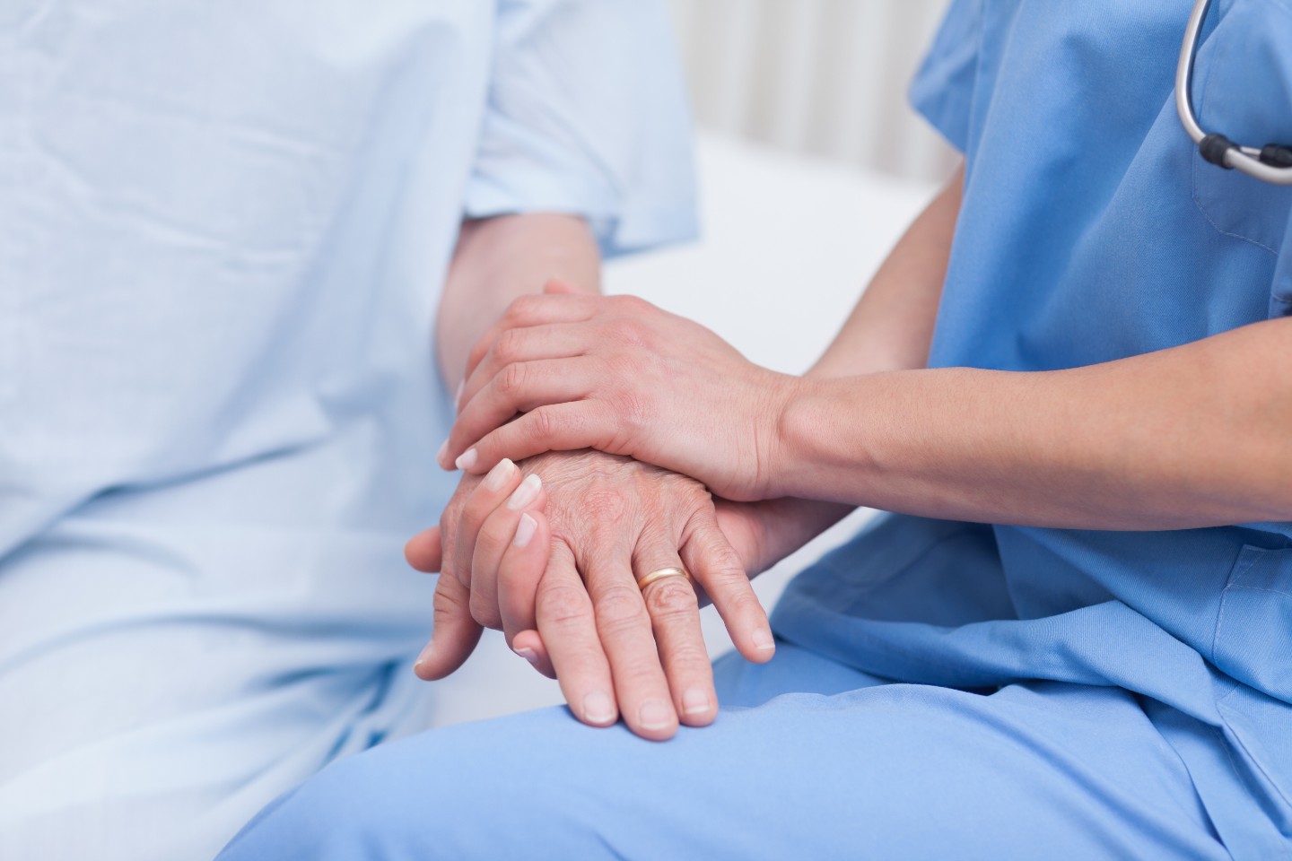 nurse holding patients hands